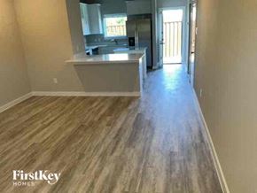 Lewisville house for rent - a kitchen with wood flooring in an empty house