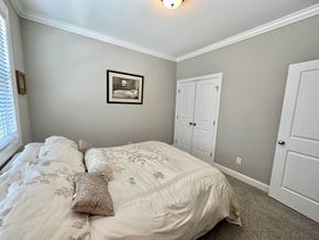 Greenville house for rent - a bedroom with a bed and two closets and a window