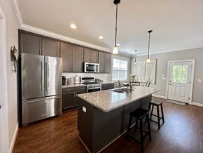 Greenville house for rent - a kitchen with stainless steel appliances and a granite counter top