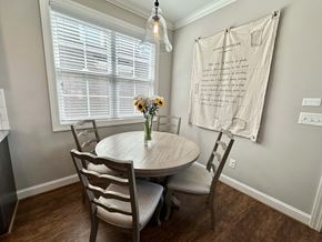Greenville house for rent - a dining room with a table and chairs and a window