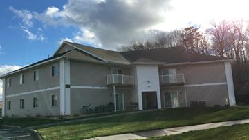 Menomonie apartment for rent - a white house with a bike parked outside of it