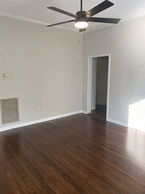 Rock Hill house for rent - an empty living room with wooden floors and a ceiling fan