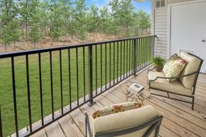 Lansdale apartment for rent - a balcony with two chairs and a view of the grass and trees