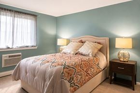 Camp Hill apartment for rent - A bedroom with a bed, nightstand, and window.
