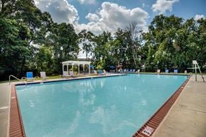 Reisterstown apartment for rent - a large swimming pool with trees in the background