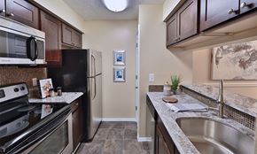 Owings Mills apartment for rent - a kitchen with stainless steel appliances and granite counter tops