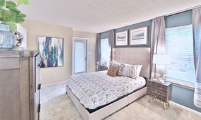 Owings Mills apartment for rent - a bedroom with a bed and a dresser and windows