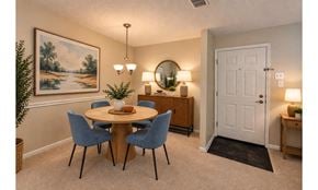 Owings Mills apartment for rent - A dining room with a round table and blue chairs.