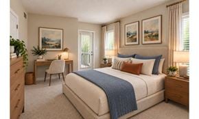 Owings Mills apartment for rent - A bedroom with a bed, desk, chair, and two framed pictures on the wall.