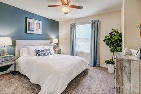 Bear townhouse for rent - a bedroom with a bed and a ceiling fan