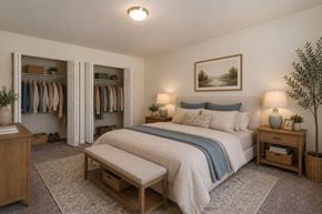 Glen Burnie apartment for rent - A bedroom with a large bed and a wardrobe.