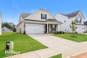 Greenville house for rent - a white house with a driveway and a garage door