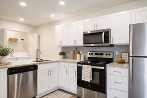 Lansdale apartment for rent - A modern kitchen with white cabinets and stainless steel appliances.