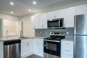 Lansdale apartment for rent - a kitchen with stainless steel appliances and white cabinets