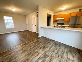 Mt. Washington apartment for rent - an empty living room and kitchen with wood floors