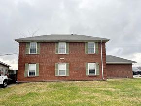 Mt. Washington apartment for rent - a red brick house with a cloudy sky in the background