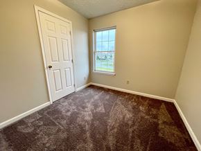 Mt. Washington apartment for rent - an empty bedroom with carpet and a white door