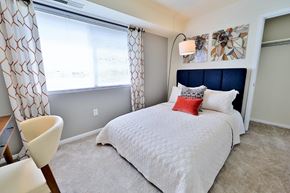 Laurel apartment for rent - a bedroom with a bed and a large window