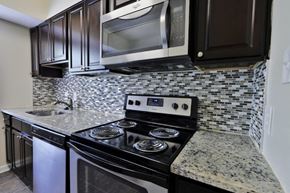 Laurel apartment for rent - a kitchen with stainless steel appliances and granite counter tops