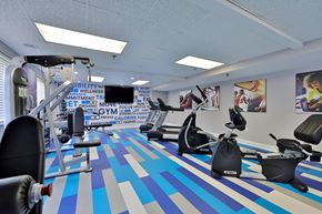 Laurel apartment for rent - a gym with various exercise machines and a tv