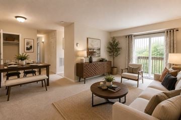 Laurel apartment for rent - A well-lit living room with a dining table and chairs.