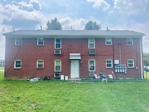 Louisville apartment for rent - A red brick house with a white door and windows.