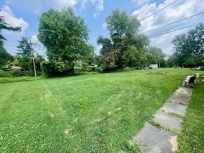 Louisville apartment for rent - A large, green, grassy yard with a concrete walkway.