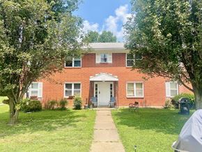 Louisville apartment for rent - A red brick house with a white door and windows.