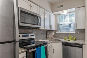 Moorestown apartment for rent - a kitchen with stainless steel appliances and white cabinets