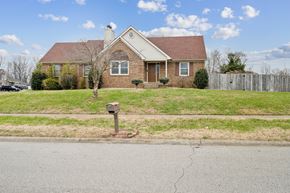 Louisville house for rent - A house with a red brick facade and a mailbox in front.