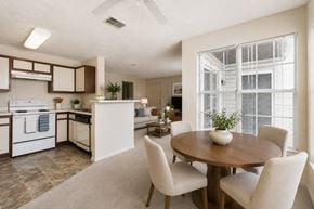 Stafford apartment for rent - A modern kitchen with a dining table and chairs.