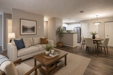 Stafford apartment for rent - A living room with a white couch, a coffee table, and a painting on the wall.
