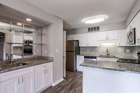 Spartanburg apartment for rent - A kitchen with white cabinets and a granite countertop.