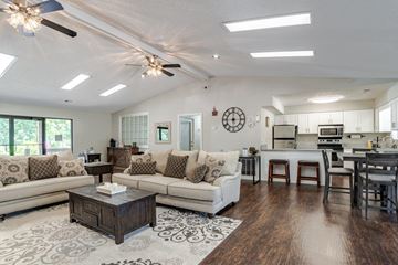 Spartanburg apartment for rent - A spacious living room with a large sectional sofa and a coffee table in the center.