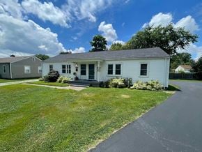 Louisville apartment for rent - A white house with a grey roof and a green lawn.