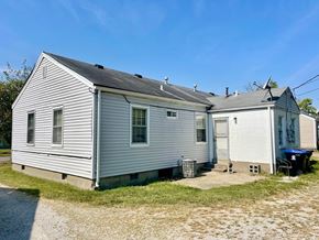 Louisville apartment for rent - A two-story house with a garage on the side.