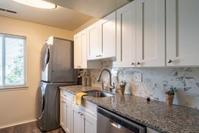 Baltimore apartment for rent - a kitchen with a granite counter top and a stainless steel refrigerator