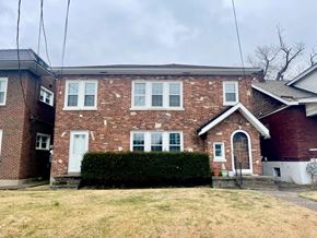 Louisville apartment for rent - a brick house with a yard in front of it