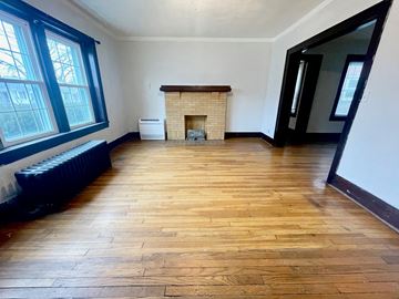 Louisville apartment for rent - a living room with a wood floor and a fireplace