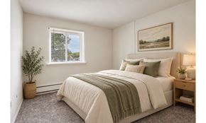 Philadelphia townhouse for rent - A bedroom with a large bed and a painting on the wall.