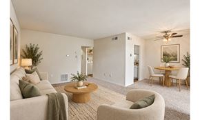 Philadelphia townhouse for rent - A living room with a couch, chairs, and a dining table.