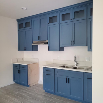 Cudahy apartment for rent - A kitchen with blue cabinets and a white counter top.