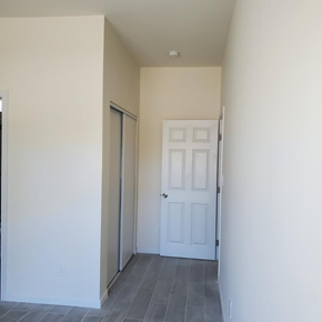 Cudahy apartment for rent - A white door is in a room with a grey floor.