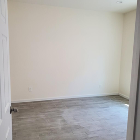 Cudahy apartment for rent - A room with a white door and a grey floor.
