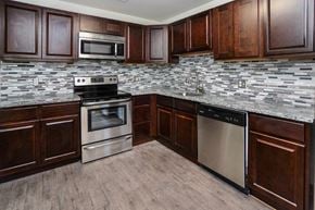 East Norriton apartment for rent - a kitchen with stainless steel appliances and wooden cabinets