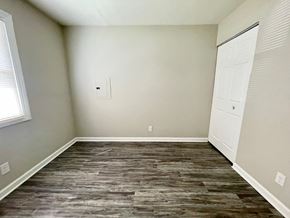 Louisville house for rent - an empty room with wood flooring and white doors
