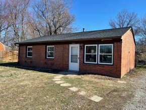 Louisville house for rent - a small brick house with a white door and windows