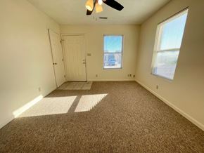 Corydon apartment for rent - an empty living room with carpet and a white door