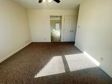 Corydon apartment for rent - a bedroom with a carpeted floor and a door to a hallway