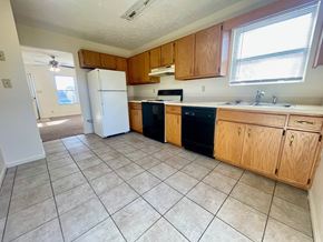 Corydon apartment for rent - an empty kitchen with a refrigerator and a sink